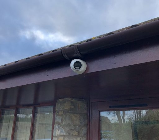 A camera on the roof of a house.