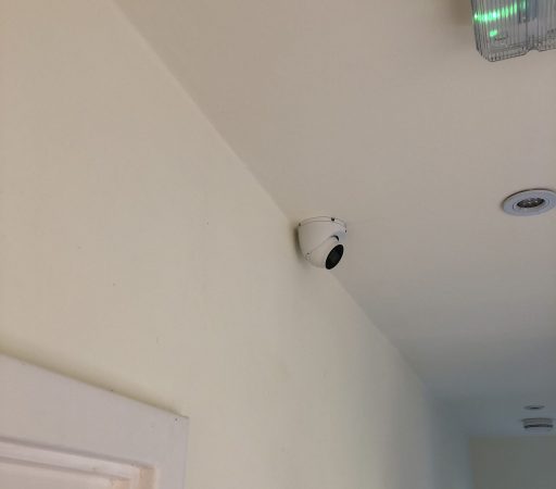 small CCTV Camera - mini CCTV camera - A camera is mounted on the ceiling of a room.