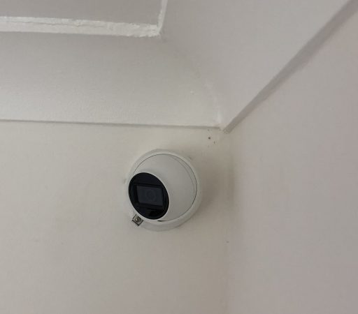A camera mounted on the ceiling of a room.