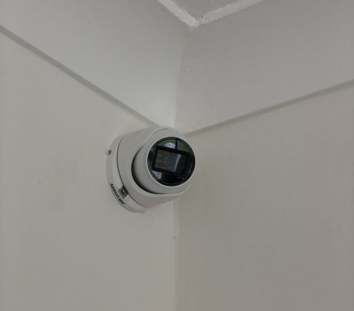 A camera mounted on the wall of a room.