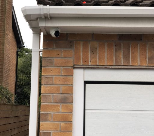 A garage with a garage door and a brick wall.